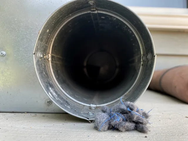 Fairhaven Dryer Vent Cleaning technician using specialized equipment to clear severe dryer vent blockage in Fairhaven